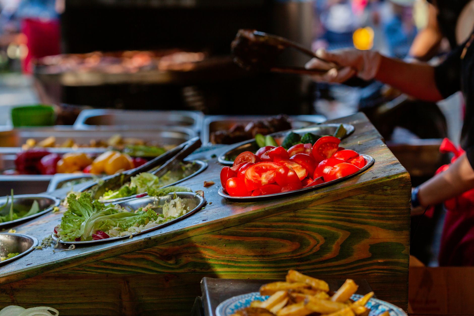 person preparing a colorful salad with various vegetables